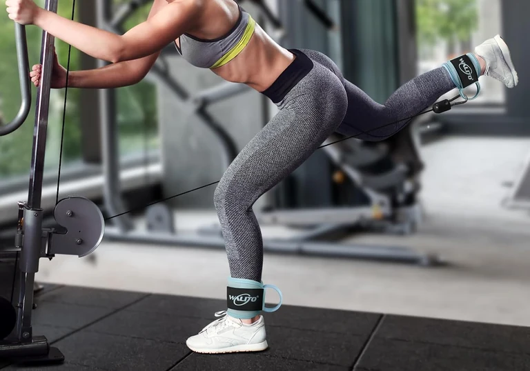 Macaron blue ankle cuff during a supported cable kickback